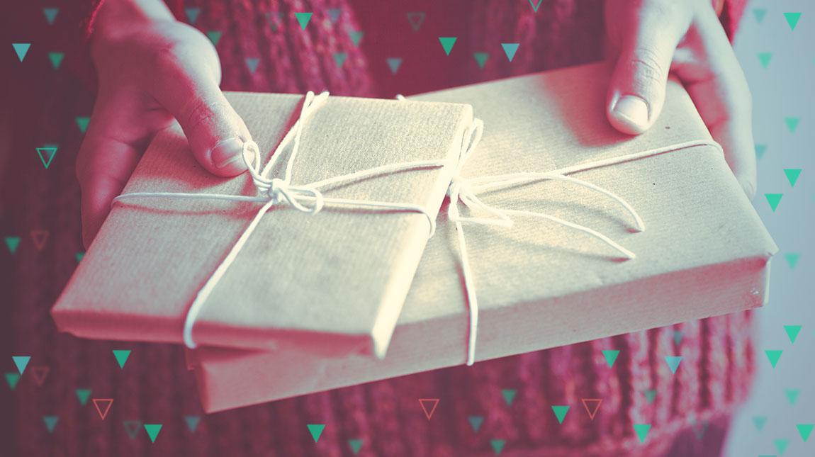 hands holding two wrapped gifts